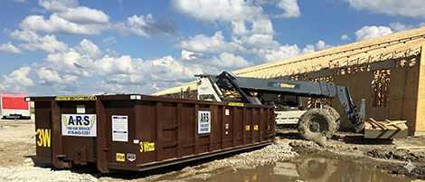 Roll-off dumpster on job site